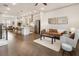 Open-concept living room featuring hardwood floors, stainless steel appliances, and stylish pendant lighting at 92 Rogers Ne St, Atlanta, GA 30317