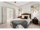 Bright primary bedroom featuring a king bed, modern decor and ensuite bathroom entrance at 92 Rogers Ne St, Atlanta, GA 30317