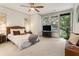 Bright primary bedroom with large windows, ceiling fan, and modern decor at 92 Rogers Ne St, Atlanta, GA 30317