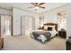Spacious primary bedroom featuring a king bed, ceiling fan and view into the bathroom at 92 Rogers Ne St, Atlanta, GA 30317