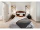 Bright primary bedroom featuring a king bed, modern decor and ensuite bathroom entrance at 92 Rogers Ne St, Atlanta, GA 30317