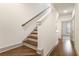 Elegant stairway with hardwood steps and white risers, leading to the upper level of the home at 92 Rogers Ne St, Atlanta, GA 30317