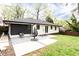 Picturesque backyard with a patio, seating, and a beautifully landscaped lawn at 2047 Seavey Dr, Decatur, GA 30032