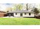 Expansive backyard with patio, lush lawn, and mature trees at 2047 Seavey Dr, Decatur, GA 30032