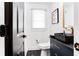 Stylish powder room featuring a black vanity, gold accents, and modern geometric floor tile at 2047 Seavey Dr, Decatur, GA 30032