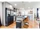 Well-lit kitchen with stainless steel appliances and open shelving provides lots of storage at 2047 Seavey Dr, Decatur, GA 30032
