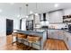 Modern kitchen with island seating, stainless appliances, and stylish light fixtures at 2047 Seavey Dr, Decatur, GA 30032