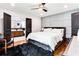 Comfortable primary bedroom showcasing wood floors, paneled wall, and ensuite access at 2047 Seavey Dr, Decatur, GA 30032