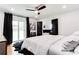 Spacious main bedroom boasts dark curtains, a ceiling fan, and ensuite access at 2047 Seavey Dr, Decatur, GA 30032