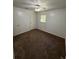Cozy bedroom featuring neutral walls, ceiling fan, and carpet flooring at 2095 Mulkey Sw Rd, Marietta, GA 30008