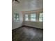 Bright bedroom with new wood floors and white walls, complemented by large windows that filter the light at 2095 Mulkey Sw Rd, Marietta, GA 30008