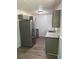 Modern kitchen with gray cabinets, stainless steel appliances, and new wood flooring at 2095 Mulkey Sw Rd, Marietta, GA 30008