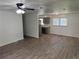 Open-concept living space featuring new wood floors and a ceiling fan, leading into the kitchen at 2095 Mulkey Sw Rd, Marietta, GA 30008