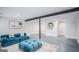 Finished basement with concrete floors, blue couch, and painted white walls at 3831 Flakes Mill Rd, Decatur, GA 30034