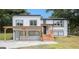 Charming renovated two-story home featuring new windows, modern finishes, and a welcoming covered porch area at 3831 Flakes Mill Rd, Decatur, GA 30034