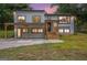 Charming renovated two-story home at dusk, featuring new windows, modern finishes, and a welcoming covered porch area at 3831 Flakes Mill Rd, Decatur, GA 30034