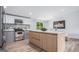 Modern kitchen featuring stainless steel appliances, a stylish backsplash, and an island with a quartz countertop at 3831 Flakes Mill Rd, Decatur, GA 30034