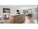 Open-concept kitchen and living area with a large island, modern decor, and plenty of natural light at 3831 Flakes Mill Rd, Decatur, GA 30034
