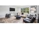 Bright and airy living room featuring a large window, modern furniture, and stylish decor at 3831 Flakes Mill Rd, Decatur, GA 30034