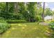 Lush backyard with mature trees and green lawn, providing a private outdoor retreat at 4307 Windward Ln, Norcross, GA 30093