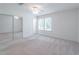 This bedroom features a large closet, plush carpeting, neutral walls, and windows that let in natural light at 4307 Windward Ln, Norcross, GA 30093