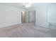 Spacious bedroom with mirrored closet, neutral carpet, and adjacent bathroom for added convenience at 4307 Windward Ln, Norcross, GA 30093
