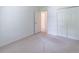 Bright bedroom featuring neutral carpet, white walls, and closet at 4307 Windward Ln, Norcross, GA 30093