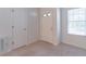 Clean entryway with white door, neutral carpet, and ample natural light from the window at 4307 Windward Ln, Norcross, GA 30093