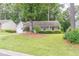Charming one-story house with lush front yard and mature trees creating a serene setting at 4307 Windward Ln, Norcross, GA 30093