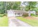 One-story home with a garage, covered front porch and lush lawn, offering great curb appeal at 4307 Windward Ln, Norcross, GA 30093
