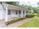 Covered front porch with a porch swing, enhanced by neatly trimmed shrubs, a welcoming entrance at 4307 Windward Ln, Norcross, GA 30093