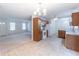 Open kitchen featuring tile floors, wood cabinets, and a view of the living room at 4307 Windward Ln, Norcross, GA 30093