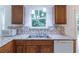 Bright kitchen with granite countertops, stainless steel sink, and wooden cabinets at 4307 Windward Ln, Norcross, GA 30093