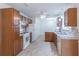 Traditional kitchen with wood cabinetry, white appliances, and tile backsplash at 4307 Windward Ln, Norcross, GA 30093