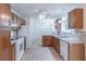 Functional kitchen with wood cabinets, tile backsplash, and modern appliances at 4307 Windward Ln, Norcross, GA 30093