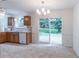 Well-lit kitchen with tile floors, wooden cabinets, and sliding glass doors to the backyard at 4307 Windward Ln, Norcross, GA 30093