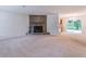 Spacious living room featuring a stone fireplace, carpeted floors, and sliding glass doors at 4307 Windward Ln, Norcross, GA 30093