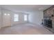 Bright living room with stone fireplace, carpet floors, and a large window at 4307 Windward Ln, Norcross, GA 30093