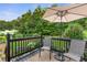 The outdoor deck features a patio umbrella, chairs, and potted plants for relaxing and entertaining at 7108 Hummingbird Ln, Winston, GA 30187