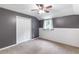 This bedroom features gray walls, carpet floors, a closet, and a window with curtains at 7108 Hummingbird Ln, Winston, GA 30187