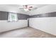 The bedroom features gray walls, carpet floors, a ceiling fan, and a window with curtains at 7108 Hummingbird Ln, Winston, GA 30187