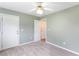 This bedroom features gray walls, carpet floors, a ceiling fan, and access to other rooms at 7108 Hummingbird Ln, Winston, GA 30187
