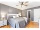 Bedroom featuring ceiling fan, wood floors, closet, and a window at 7108 Hummingbird Ln, Winston, GA 30187