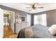 Bedroom featuring ceiling fan, wood floors, closet, and a window at 7108 Hummingbird Ln, Winston, GA 30187