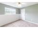 This bedroom features gray walls, a ceiling fan, carpet floors, a window and a door at 7108 Hummingbird Ln, Winston, GA 30187