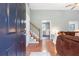 Bright entryway featuring hardwood floors, staircase, open access to the kitchen and living room at 7108 Hummingbird Ln, Winston, GA 30187