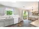 Kitchen featuring stainless steel appliances, white cabinets, and view through sliding door at 7108 Hummingbird Ln, Winston, GA 30187