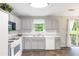 Modern kitchen with tile floors, gray cabinets, ample counter space and stainless steel appliances at 7108 Hummingbird Ln, Winston, GA 30187