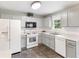 Well-lit kitchen featuring stainless steel appliances, white cabinets, and white countertops at 7108 Hummingbird Ln, Winston, GA 30187