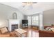 Inviting living room with a fireplace, large windows, hardwood floors and vaulted ceiling at 7108 Hummingbird Ln, Winston, GA 30187